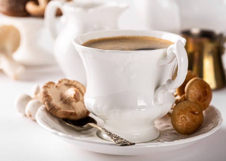 A white cup with steaming-hot mushroom coffee